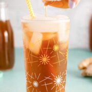 pouring ginger syrup into ginger ale