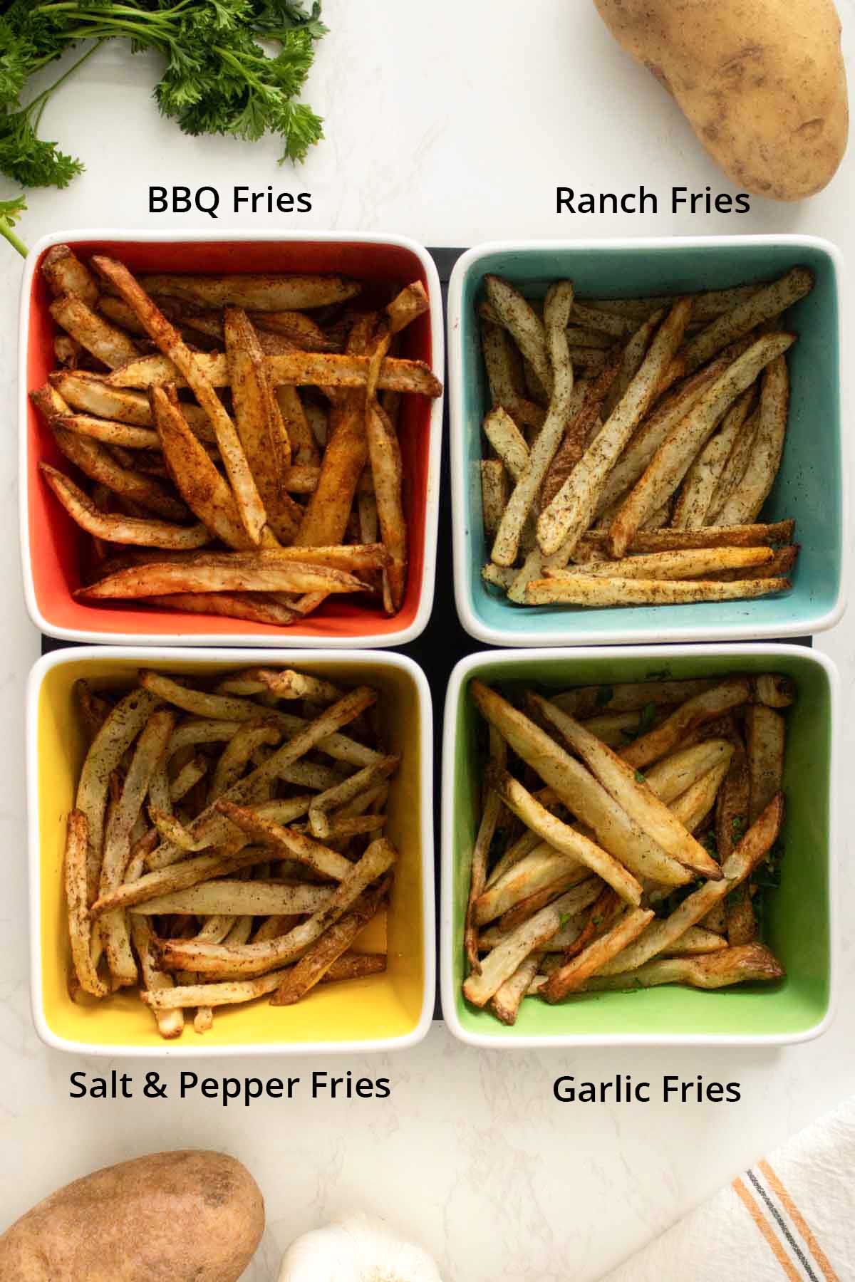 air fryer fries, after seasoning and serving, text labels on each flavor