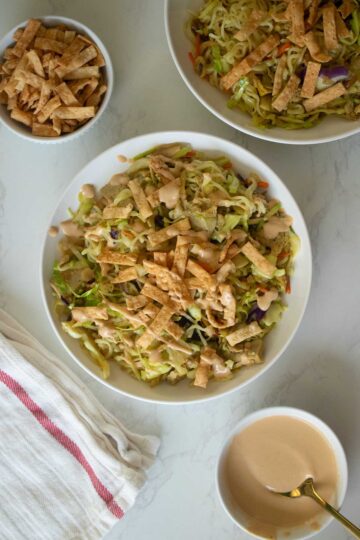 vegan egg roll in a bowl on a table with toppings around it