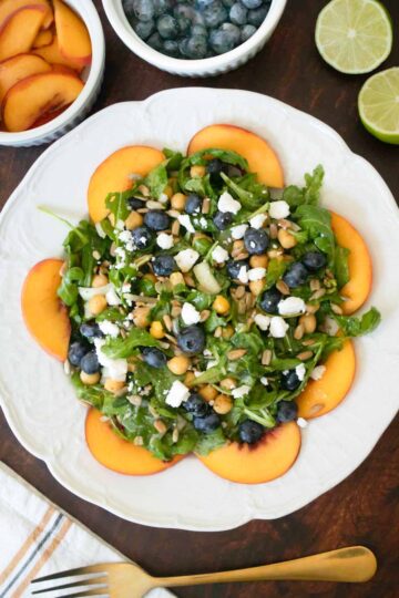 blueberry peach salad on a white plate