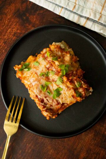 vegan meat lasagna on a plate with a fork