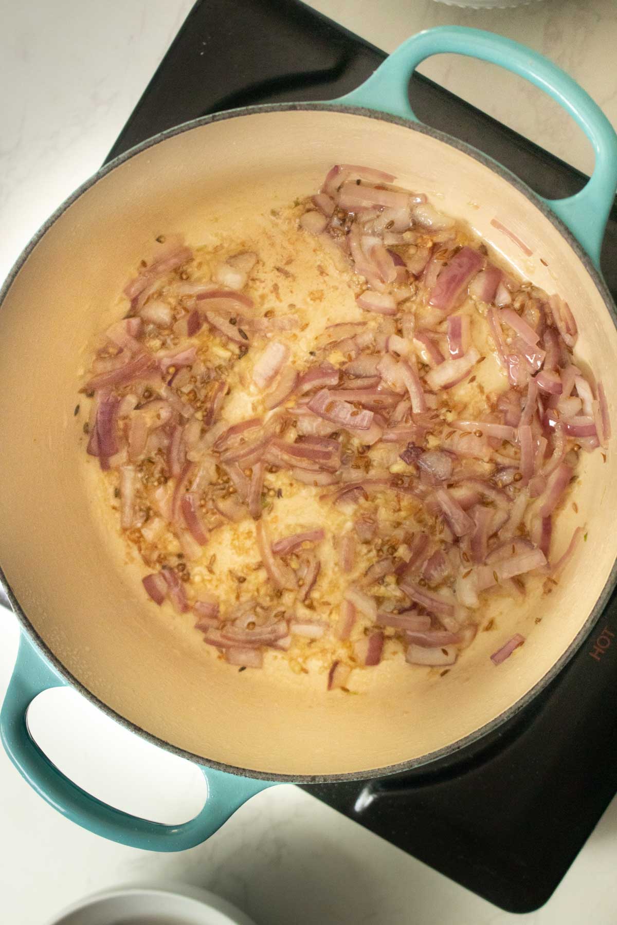 sautéed onion, garlic, and whole spices in the pot