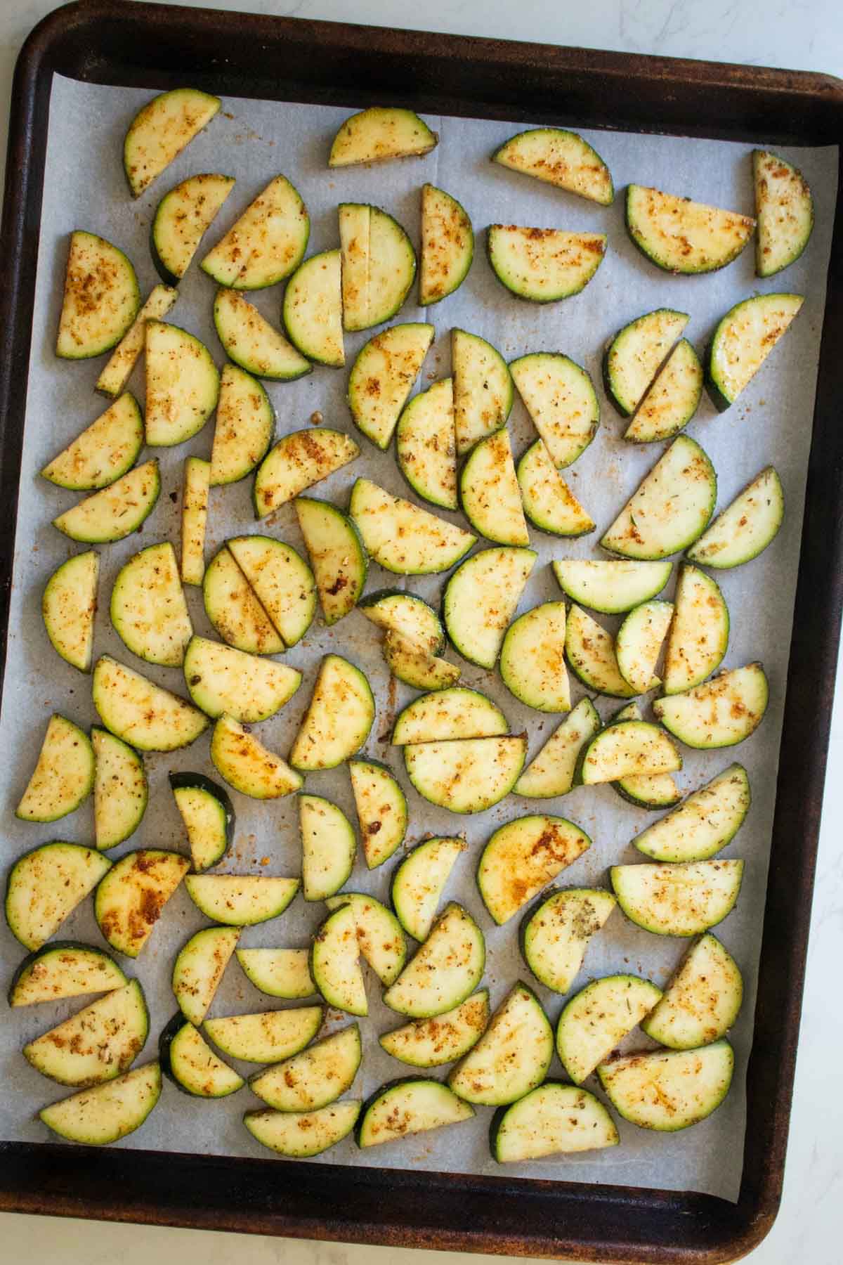 zucchini on the baking sheet before baking