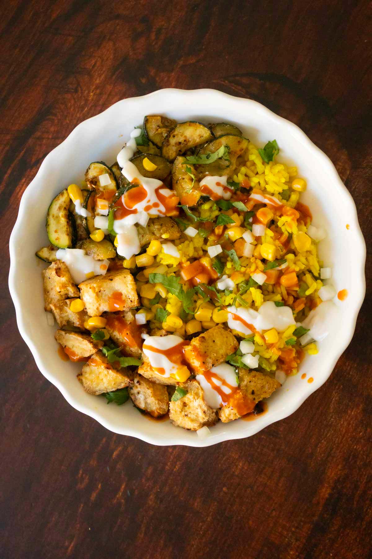 adding toppings to the Mexican-inspired crispy tofu bowl