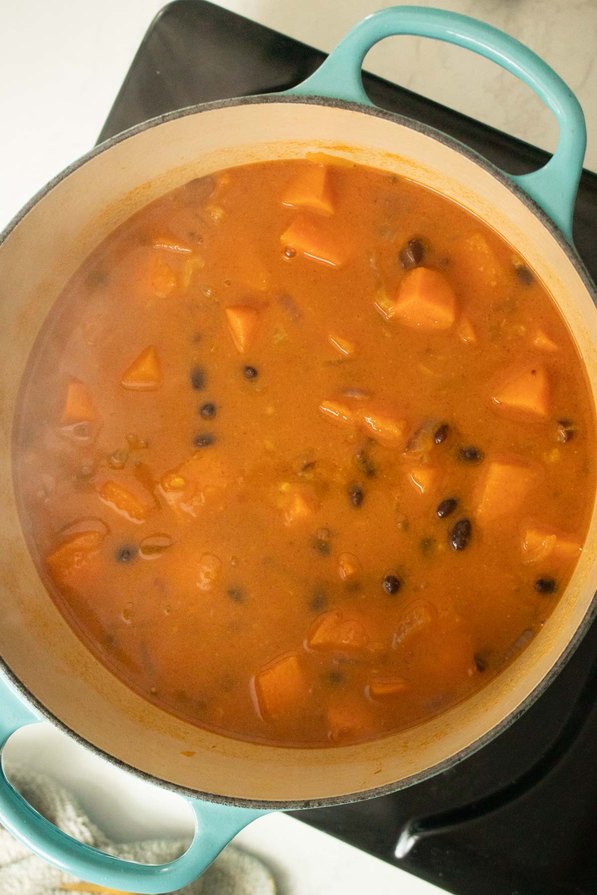 black bean sweet potato soup after stirring in the coconut milk
