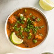 bowl of black bean sweet potato soup after adding toppings