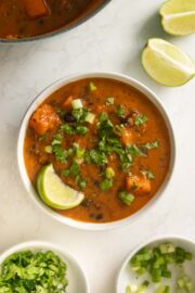 bowl of black bean sweet potato soup after adding toppings
