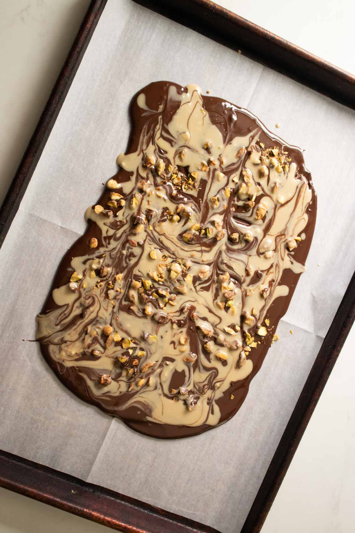 chocolate pistachio bark after swirling in the tahini
