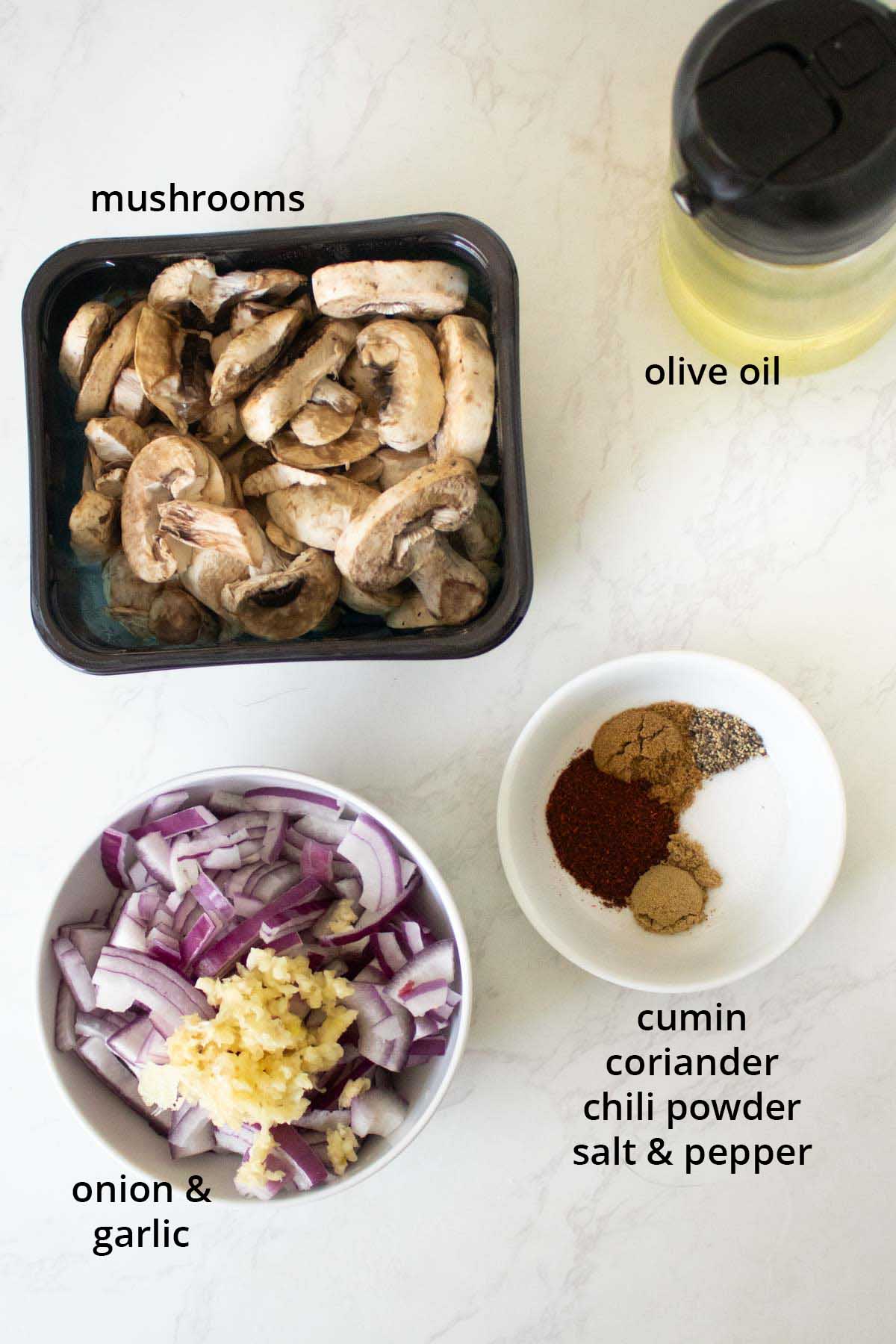 cumin mushrooms ingredients in bowls on a white table, text labels