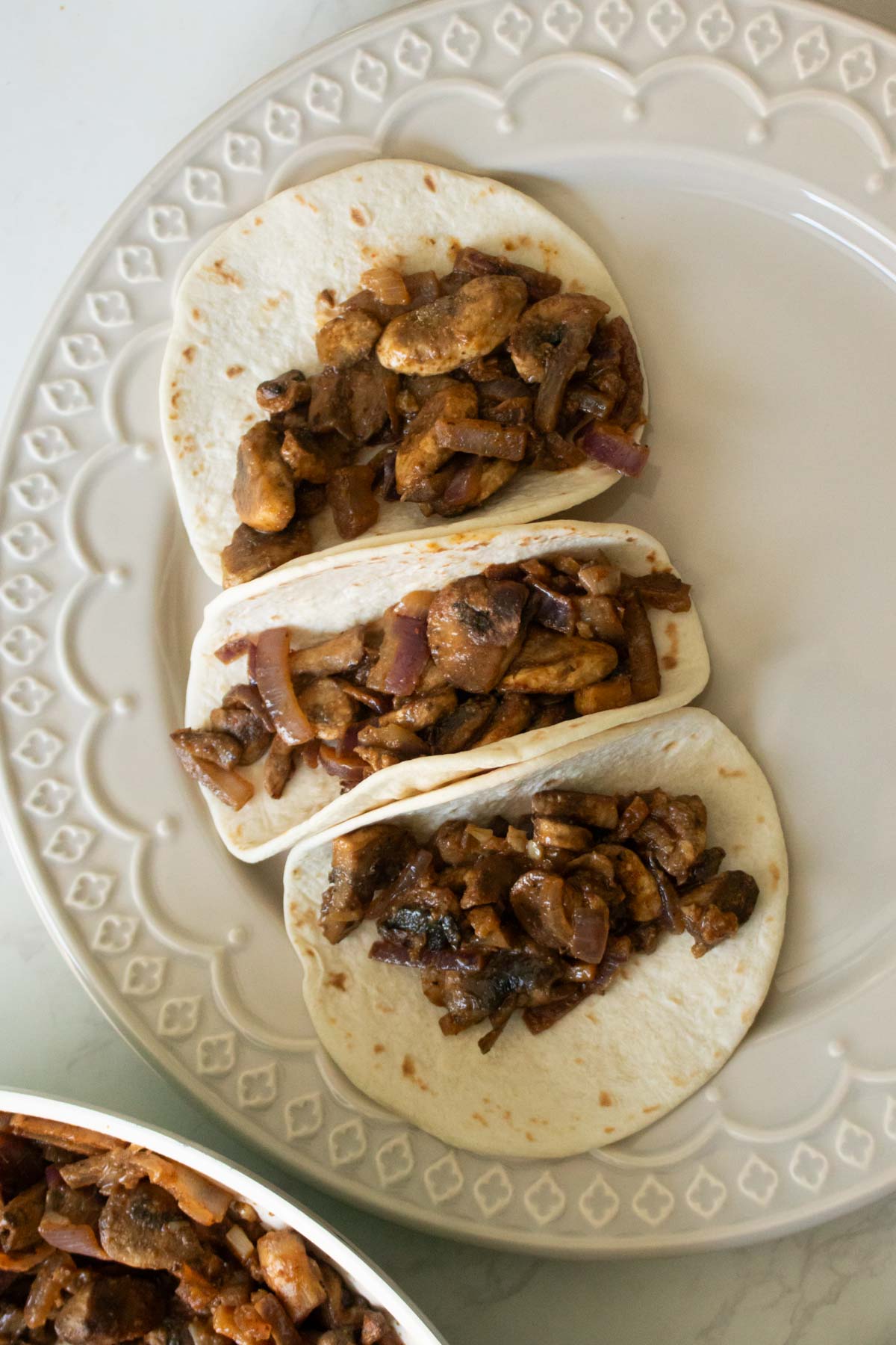 adding mushrooms to tortillas