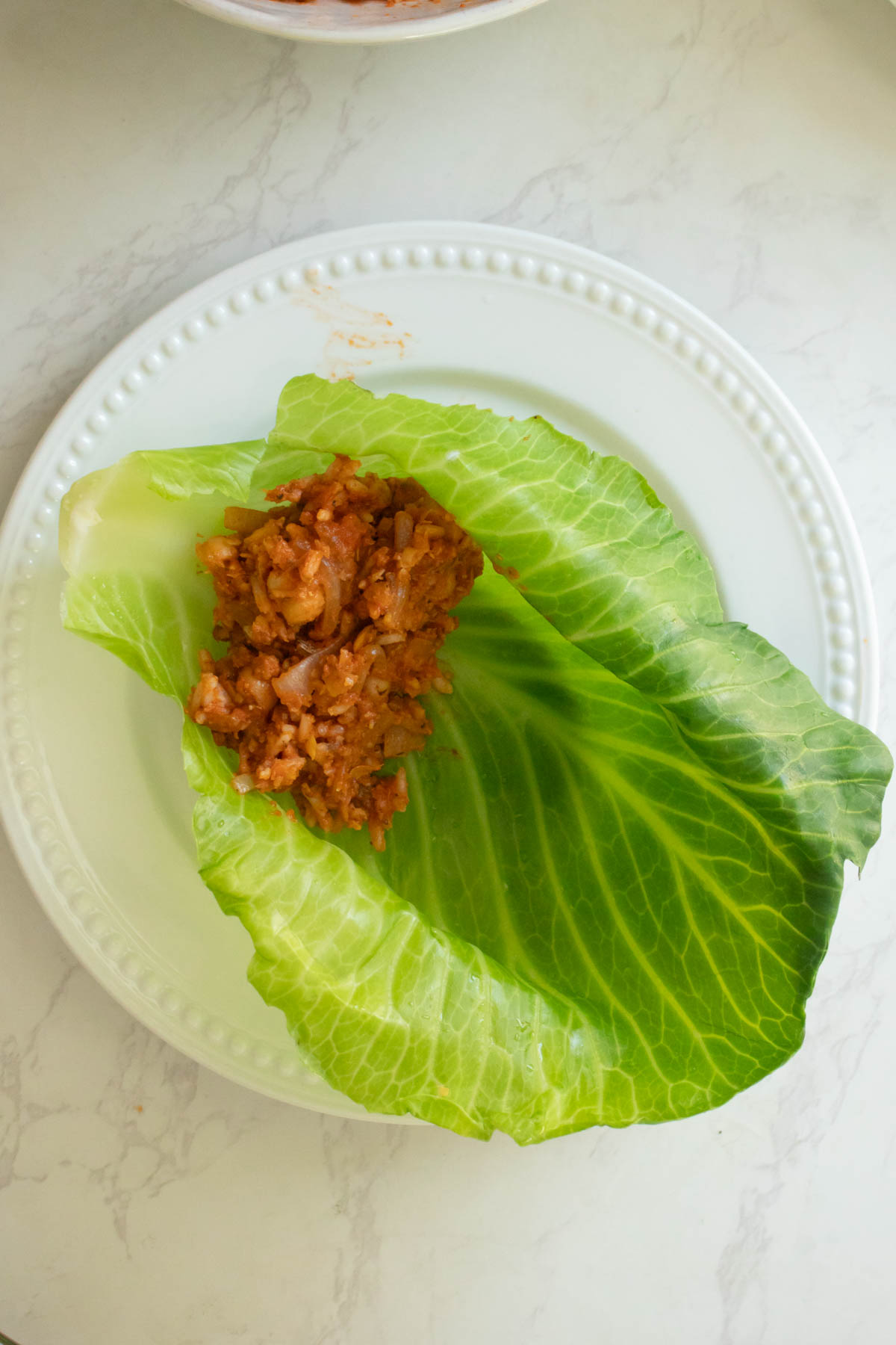 placing filling into a cabbage leaf
