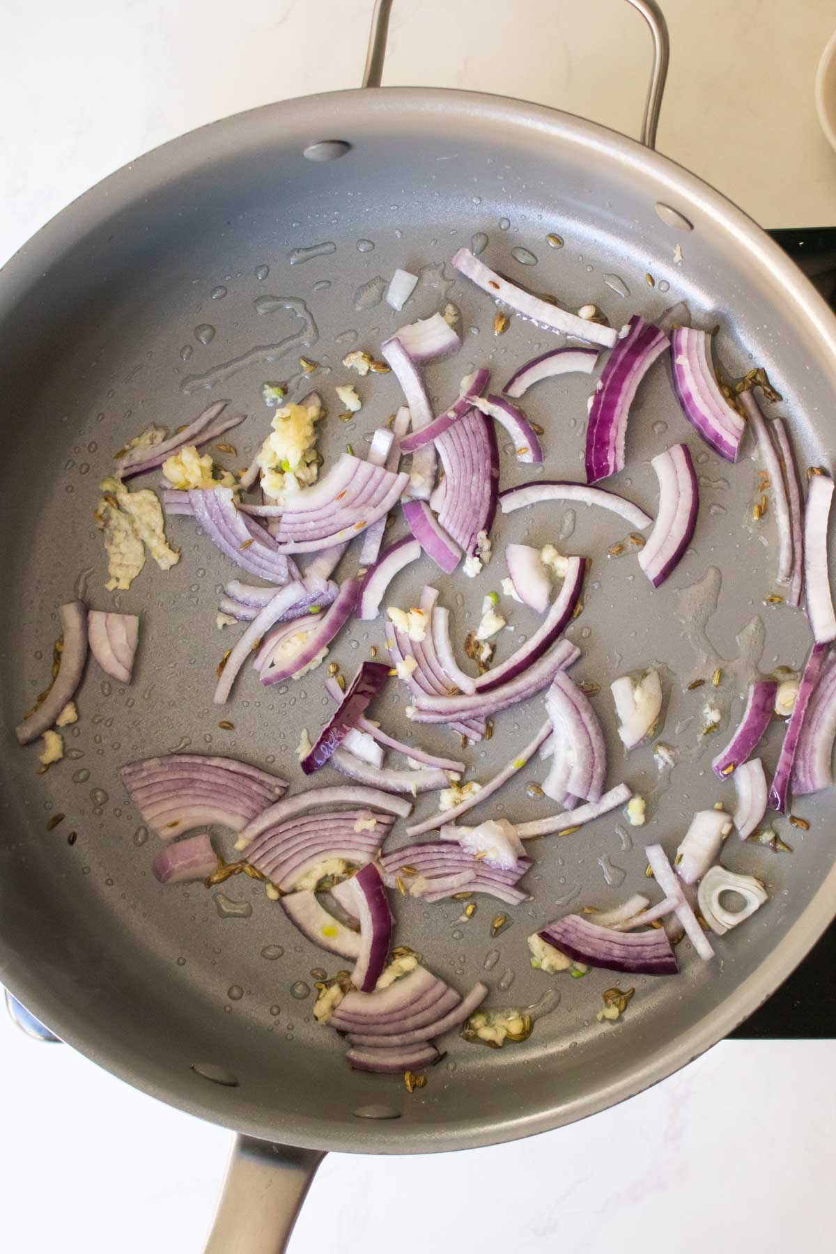 fennel, onion, and garlic in the pan before cooking