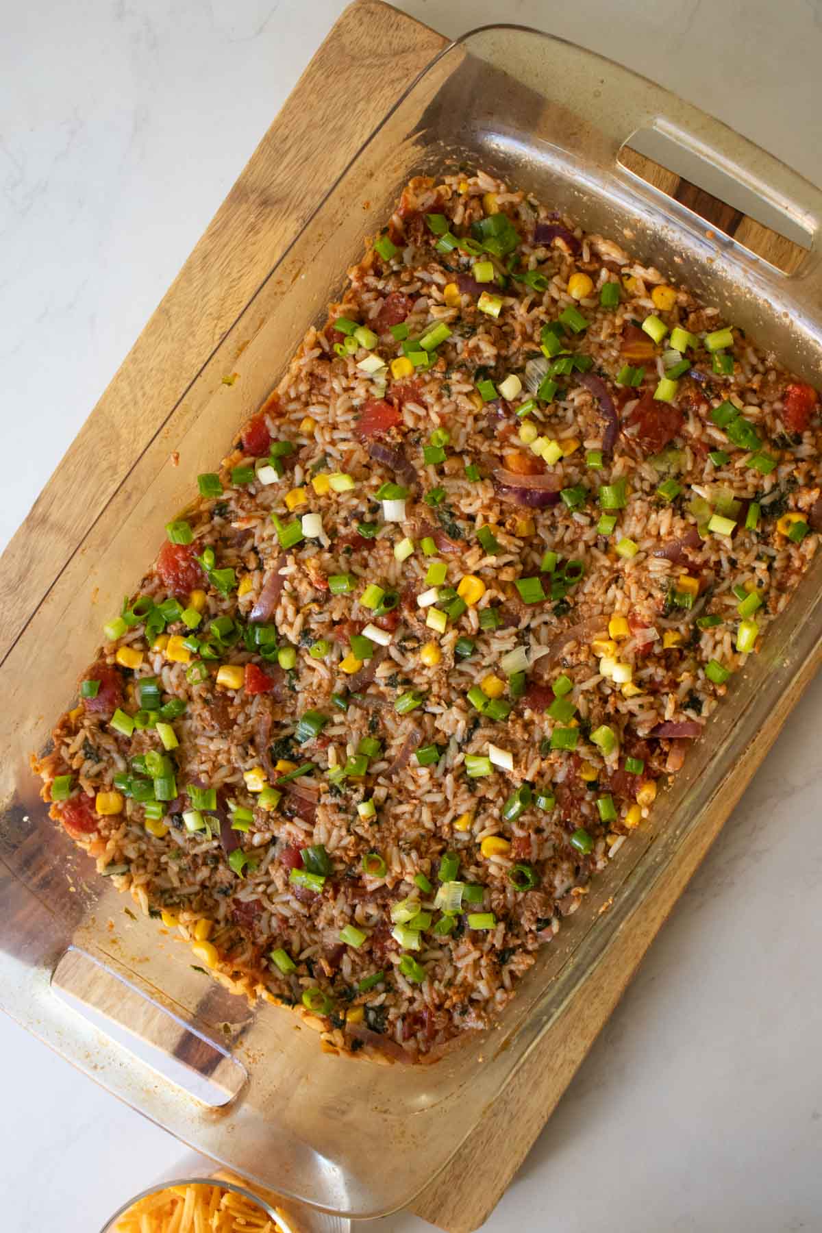 topping the vegan taco casserole with green onion