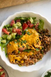 vegan taco casserole in a bowl with tomato avocado salad
