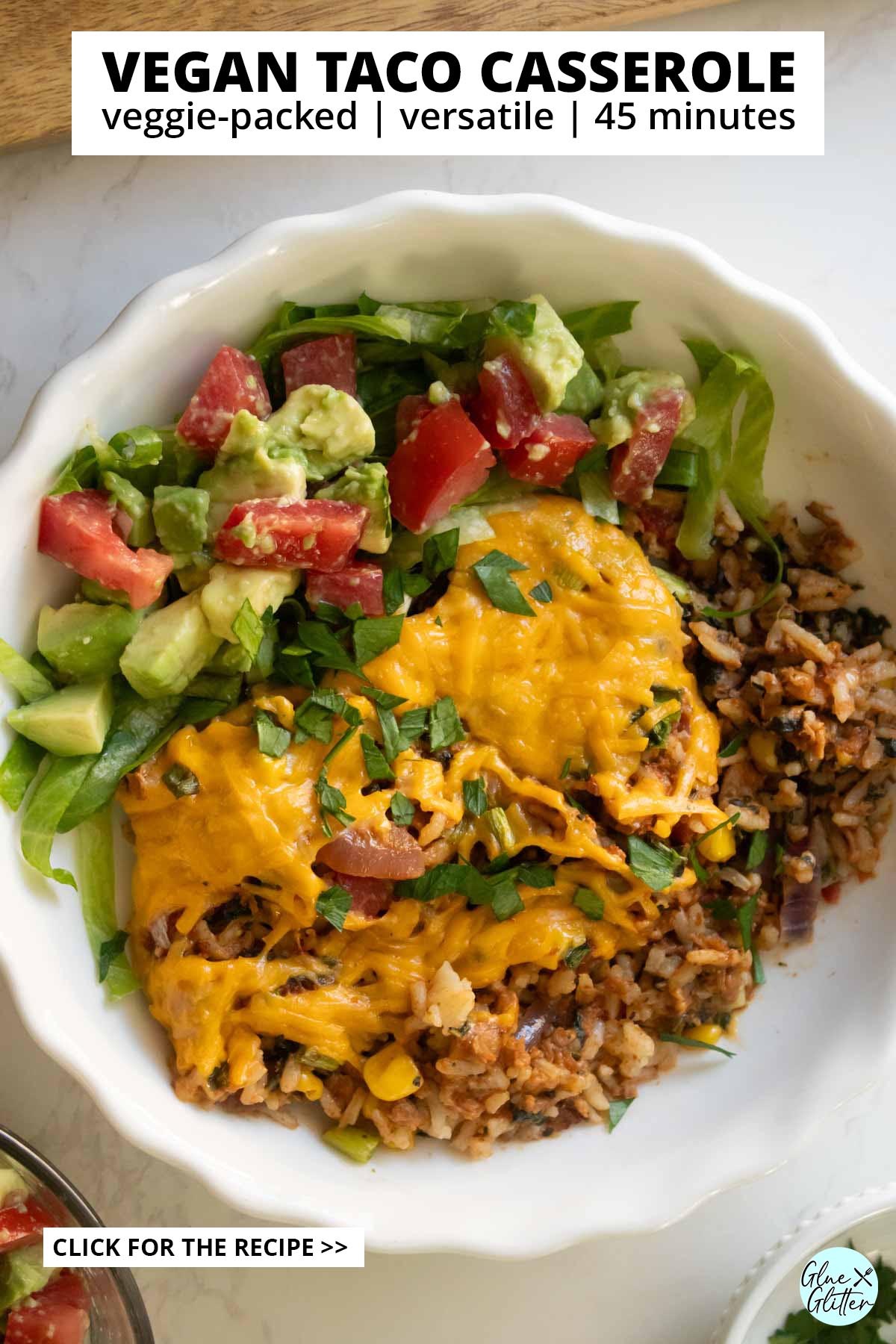 vegan taco casserole in a bowl with tomato avocado salad, text overlay