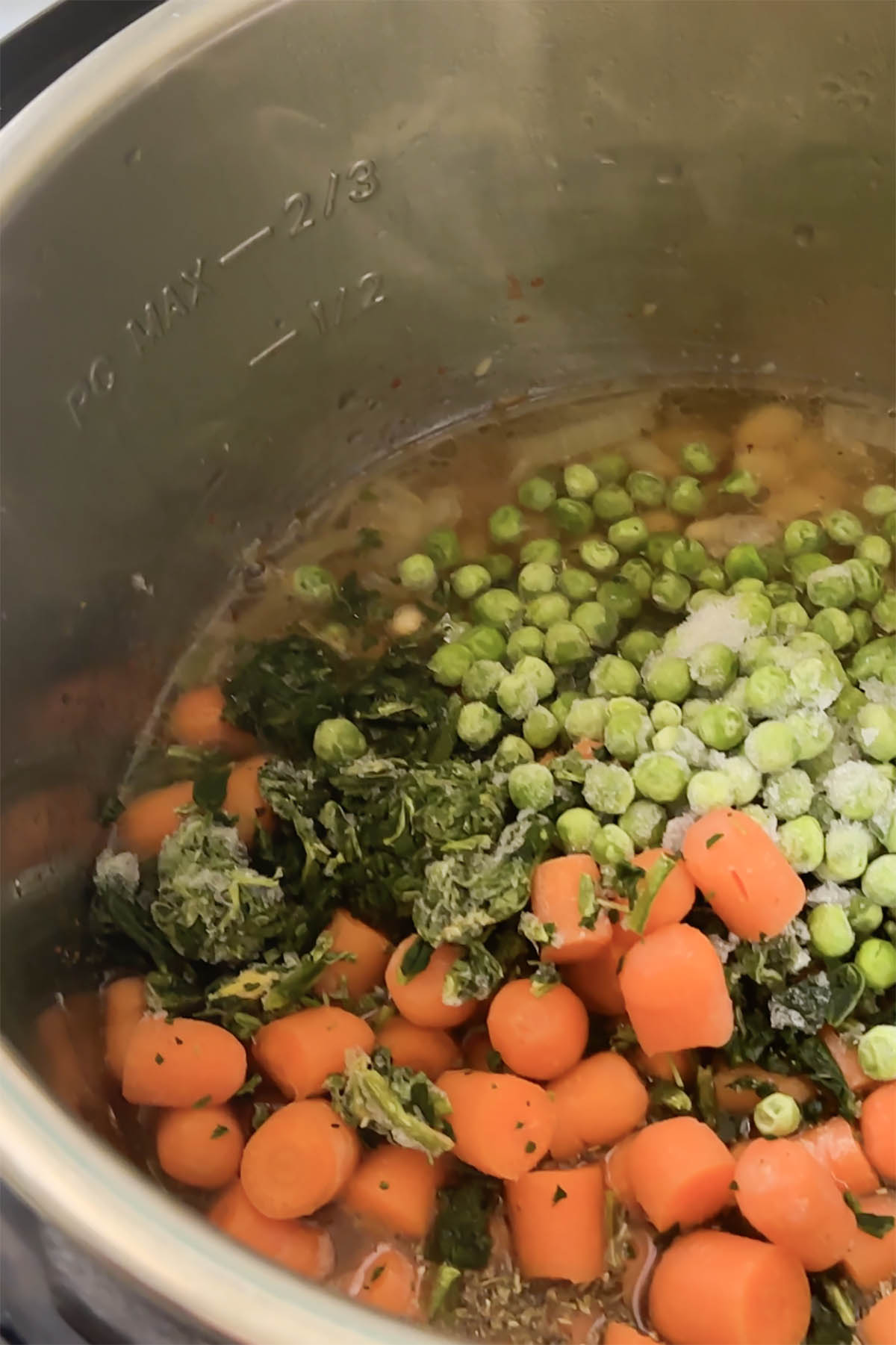 adding broth, spices, and veggies to the pot