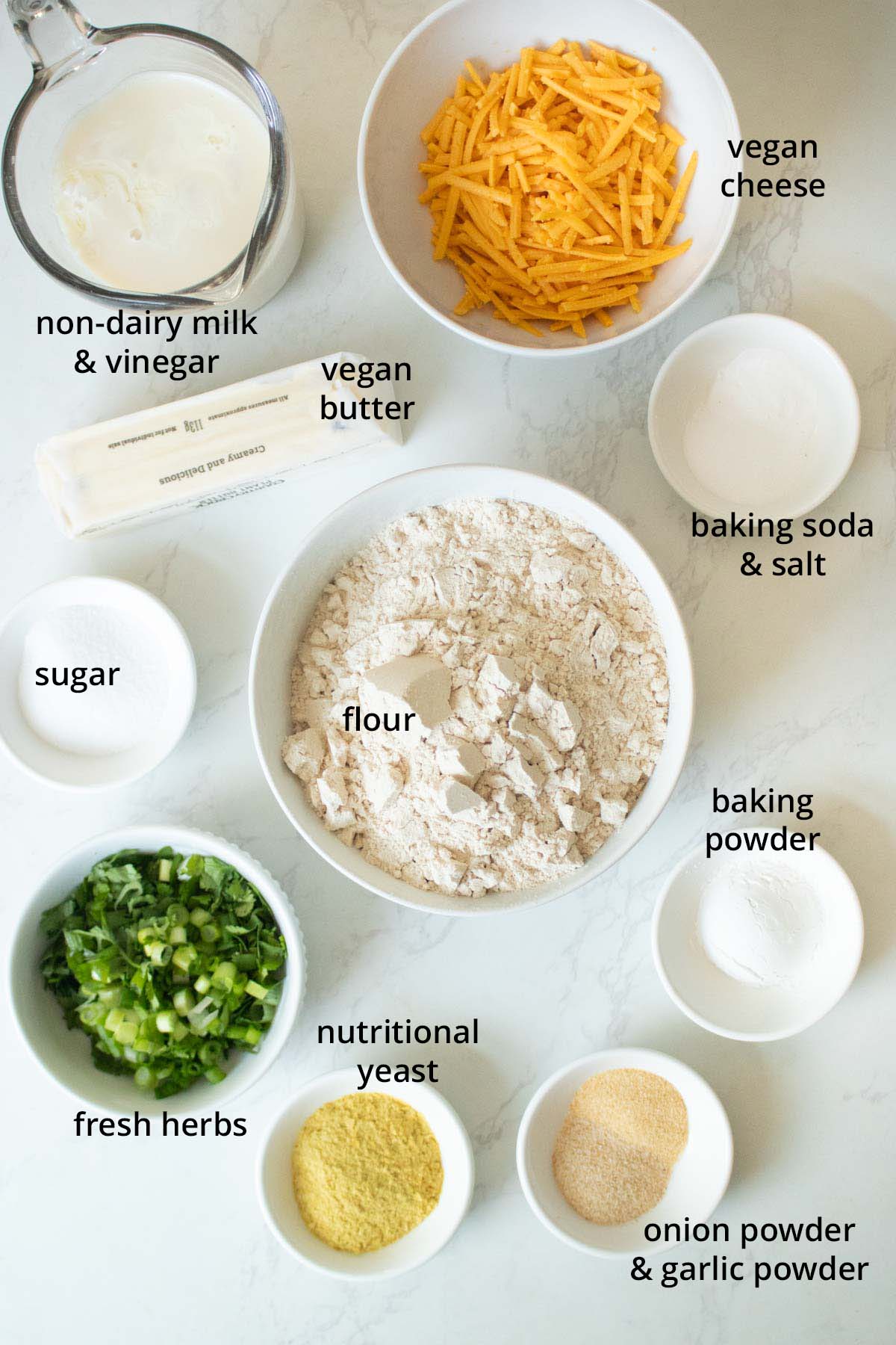 savory vegan scones ingredients in bowls on a white table
