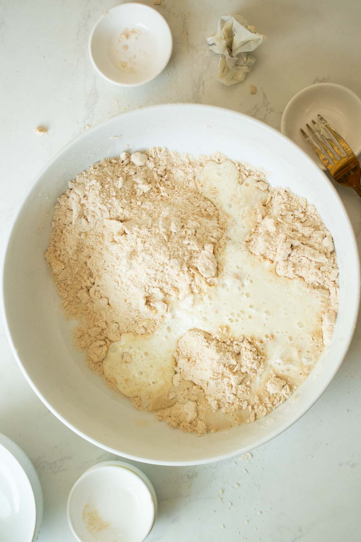 adding vegan buttermilk to the sandy mixture