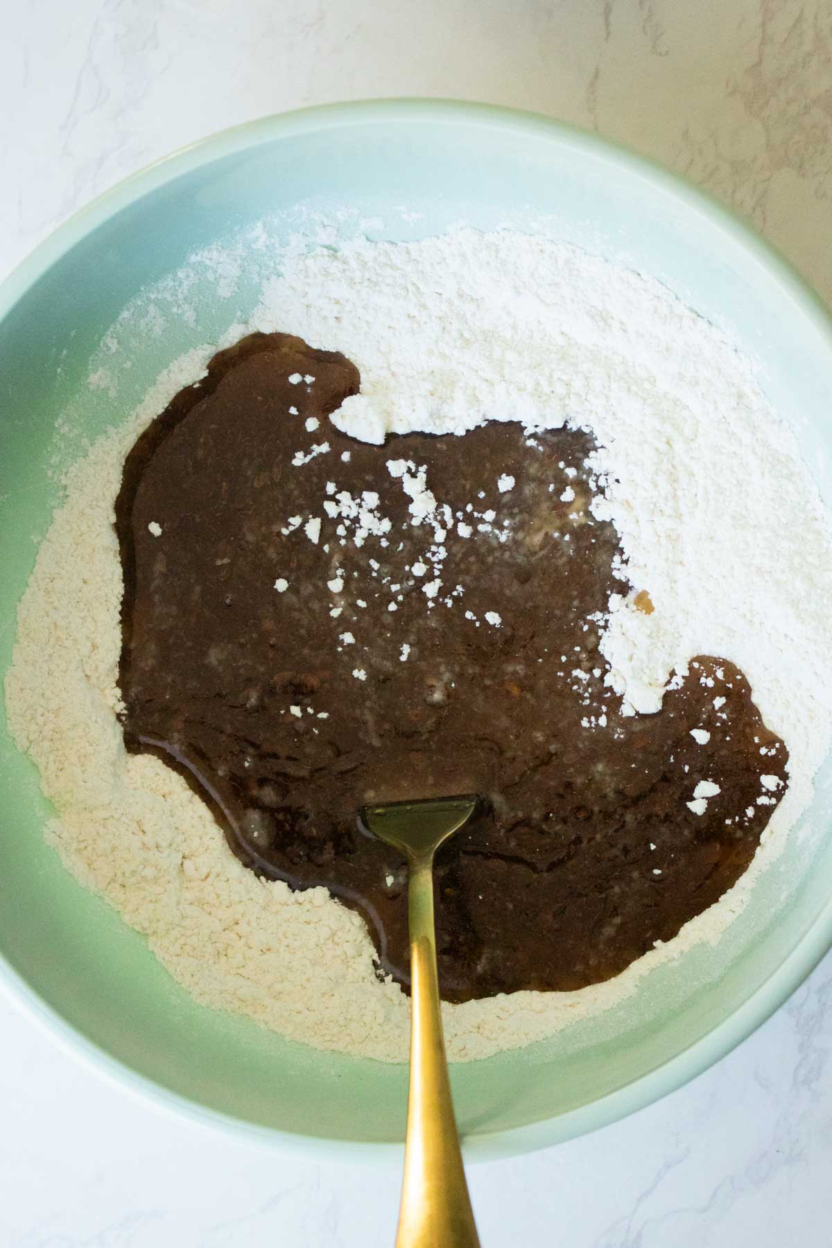 adding wet ingredients to the dry ingredients
