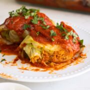 vegan rolled cabbage with a bite taken out, so you can see the filling