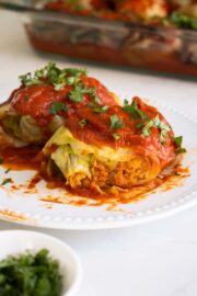 vegan rolled cabbage with a bite taken out, so you can see the filling