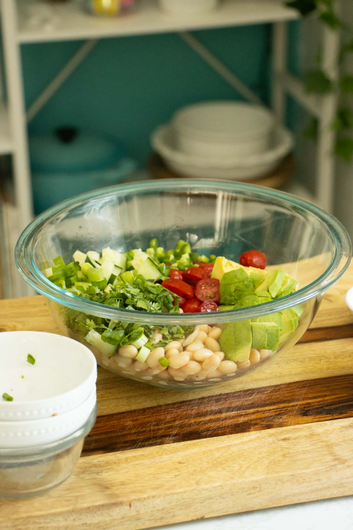 avocado white bean salad ingredients in the mixing bowl bowl before adding dressing