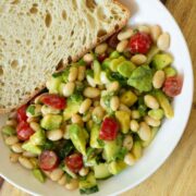 bowl of avocado white bean salad with toast to dip