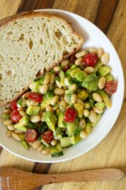 bowl of avocado white bean salad with toast to dip