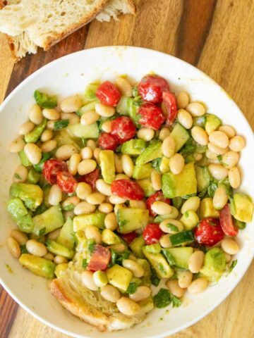 bowl of avocado white bean salad after dipping the bread