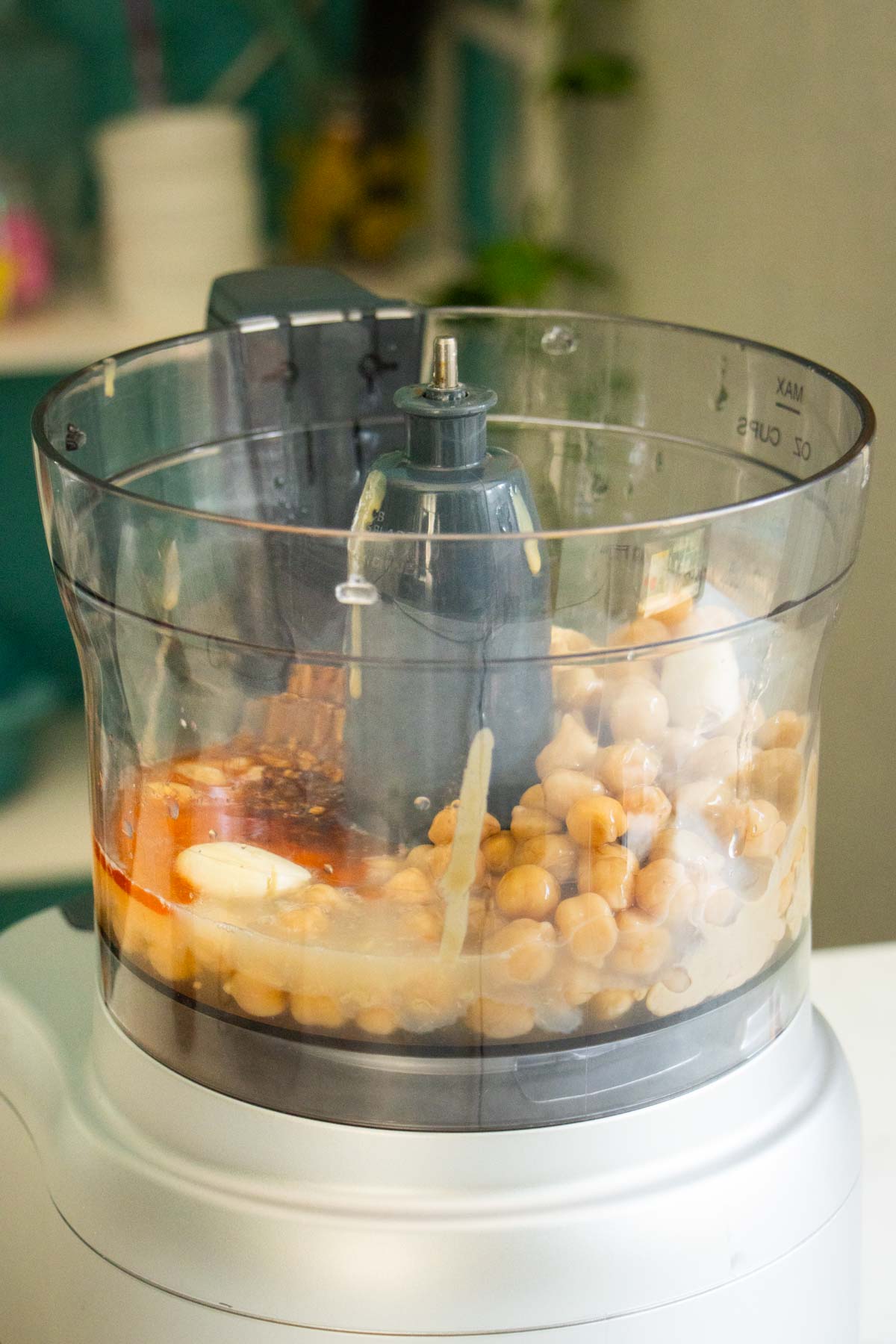 chili crisp hummus ingredients in the food processor before running it