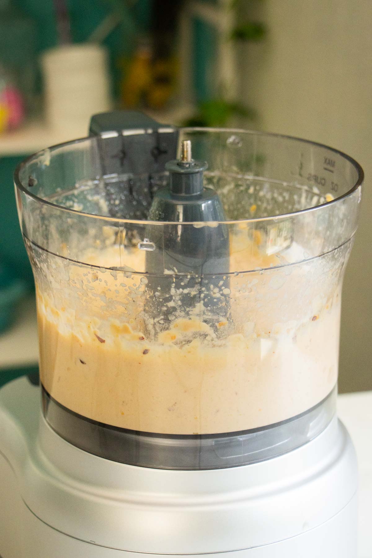 chili crisp hummus ingredients in the food processor after running it