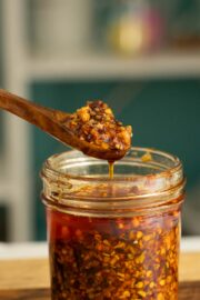 spoon serving chili onion crunch from a jar