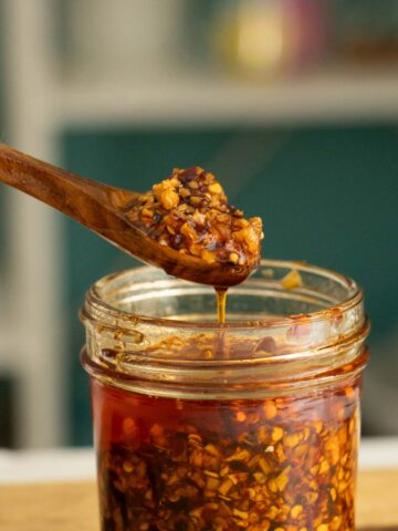 spoon serving chili onion crunch from a jar