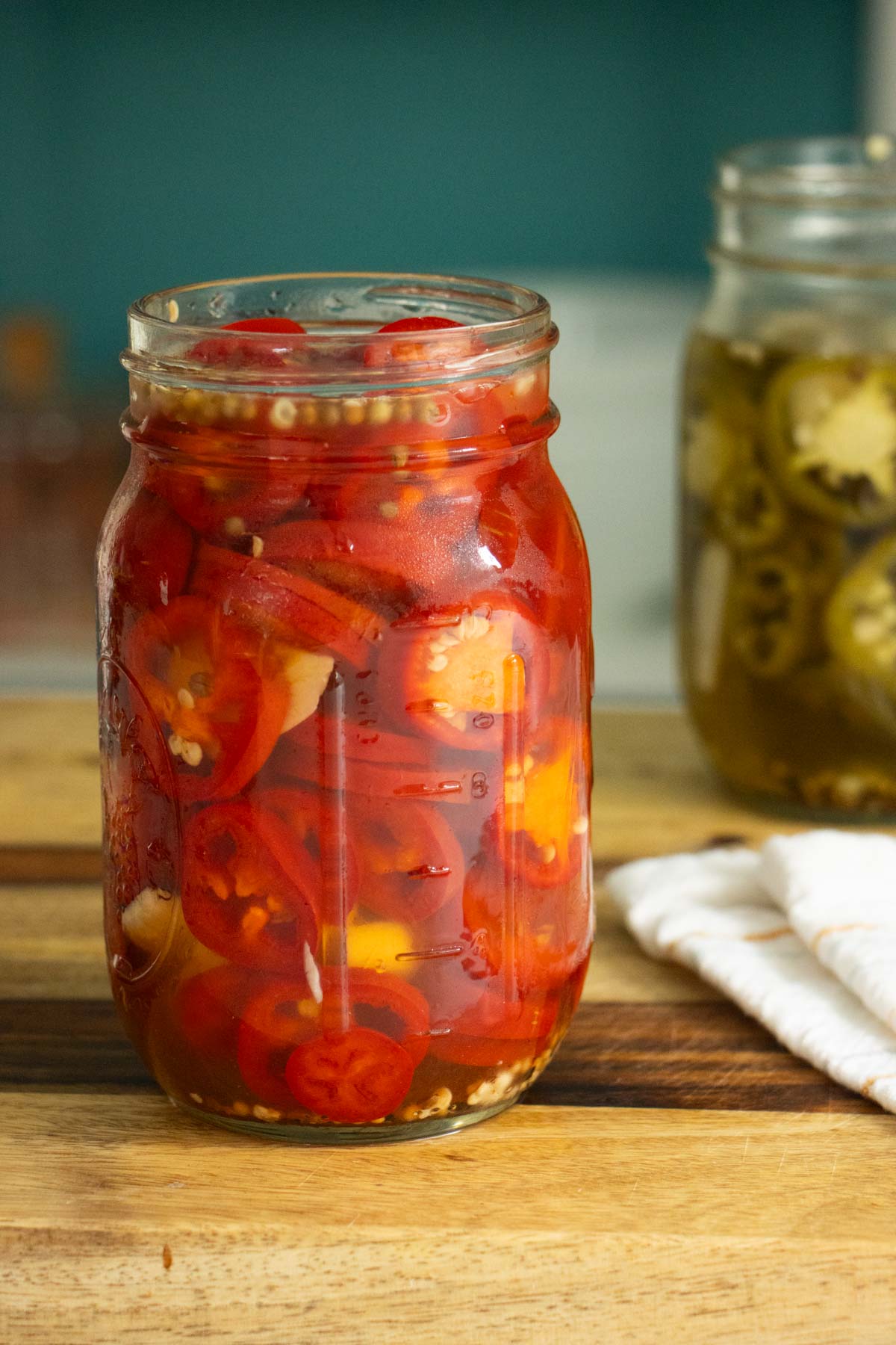 jars of quick pickled chilies on the kitchen counter