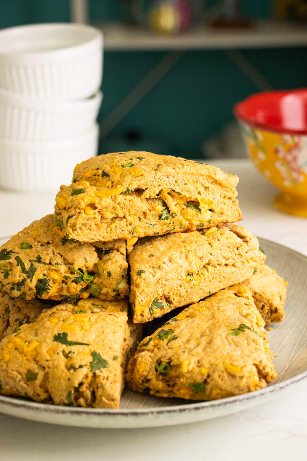 savory vegan scones piled onto a plate
