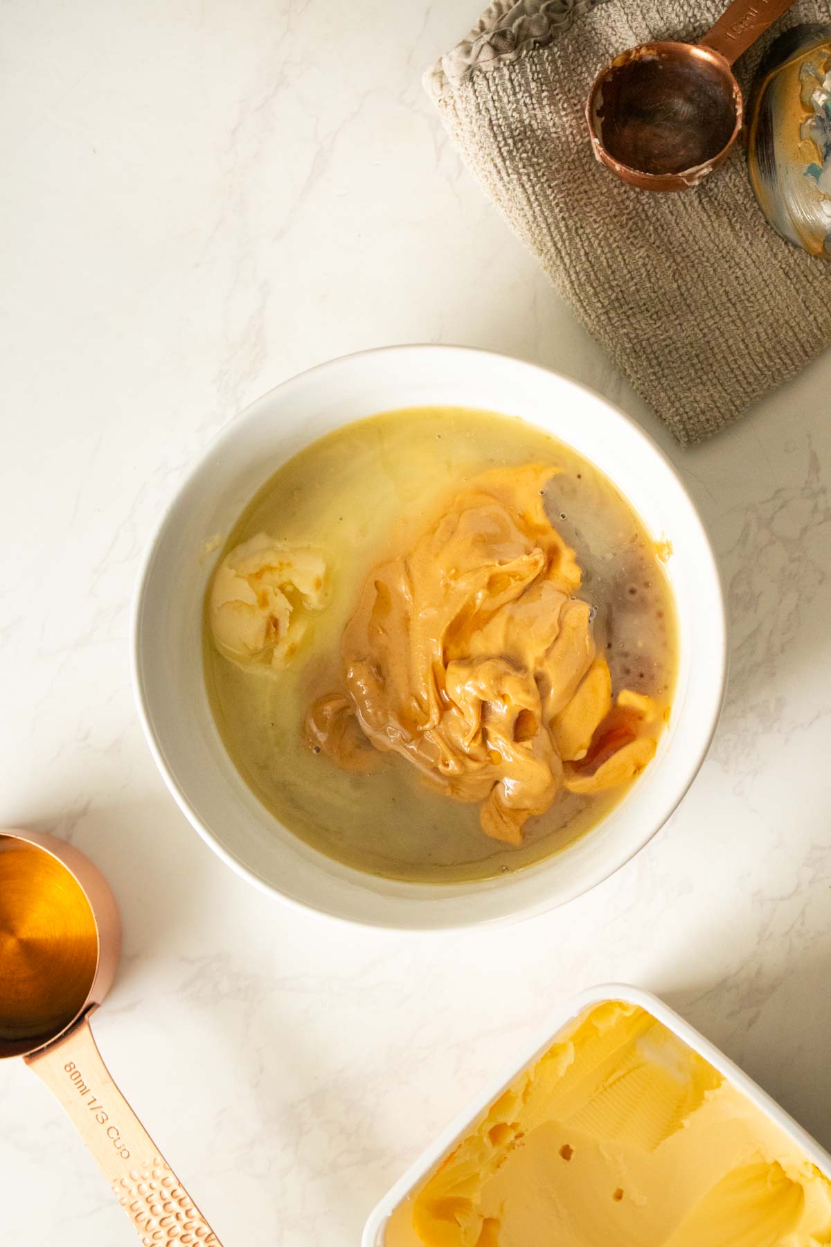 peanut butter, maple syrup, and vegan butter in the bowl before melting