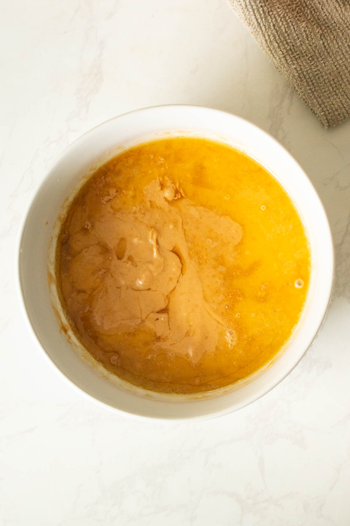 peanut butter, maple syrup, and vegan butter in the bowl after melting