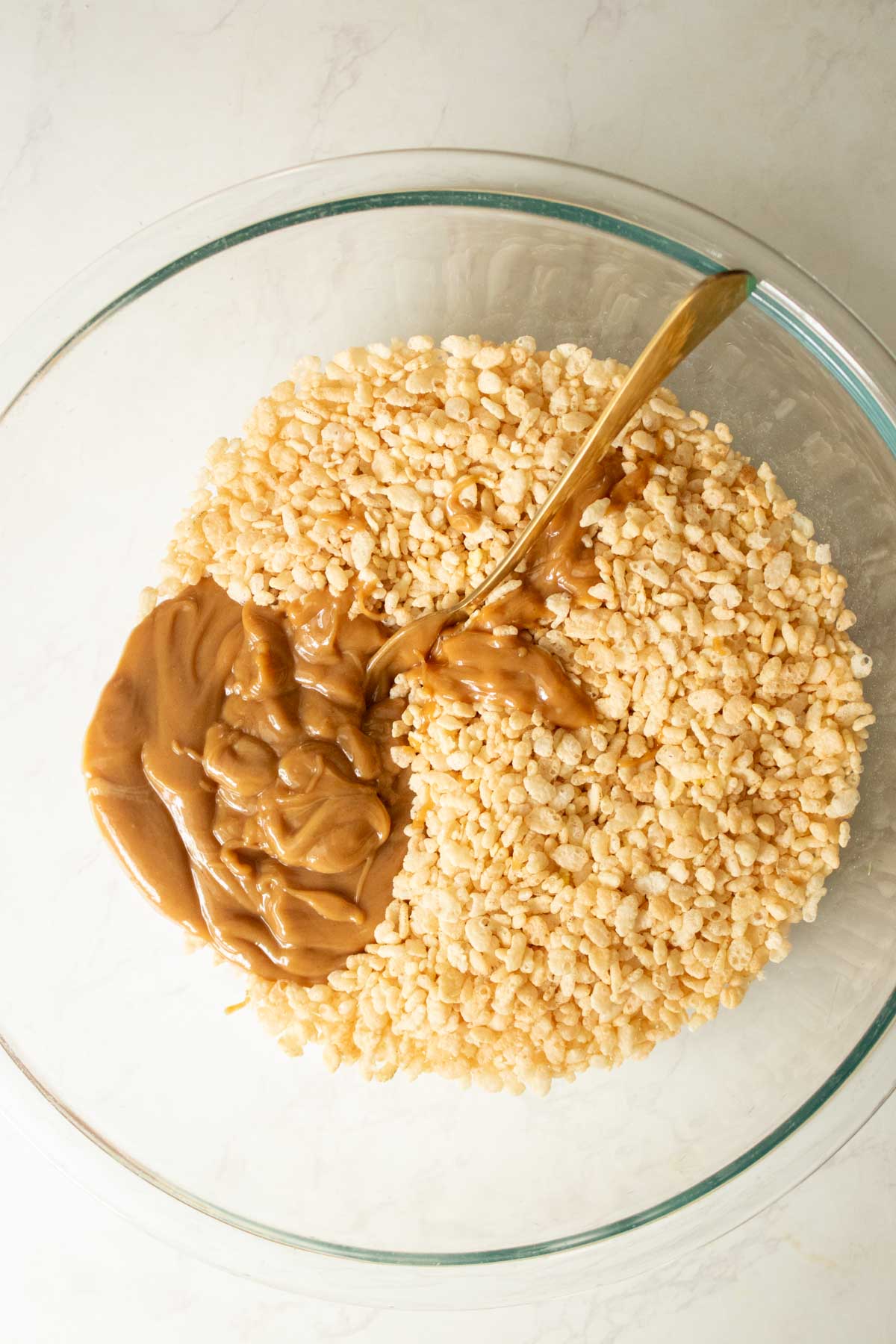 adding the peanut butter mixture to the bowl of cereal