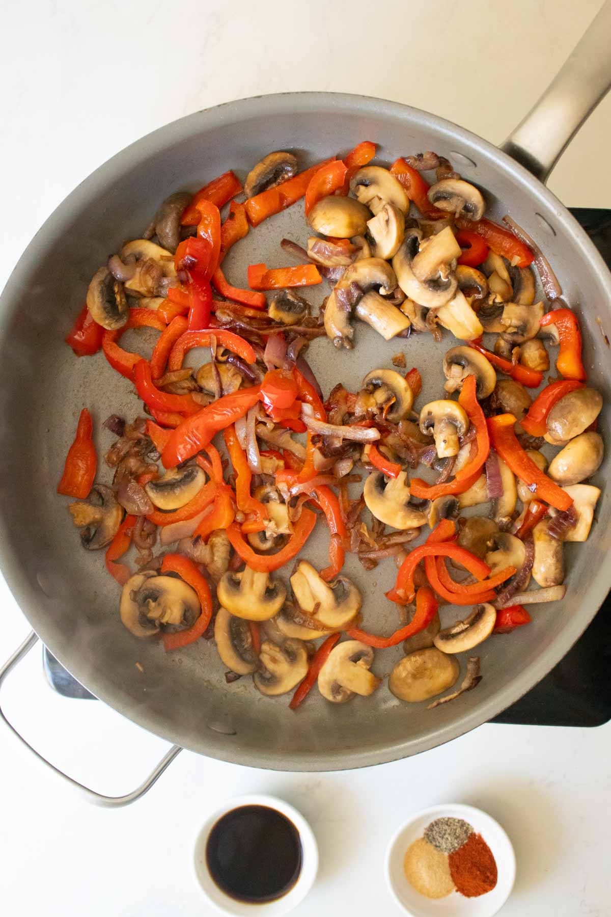 adding mushrooms to the pan