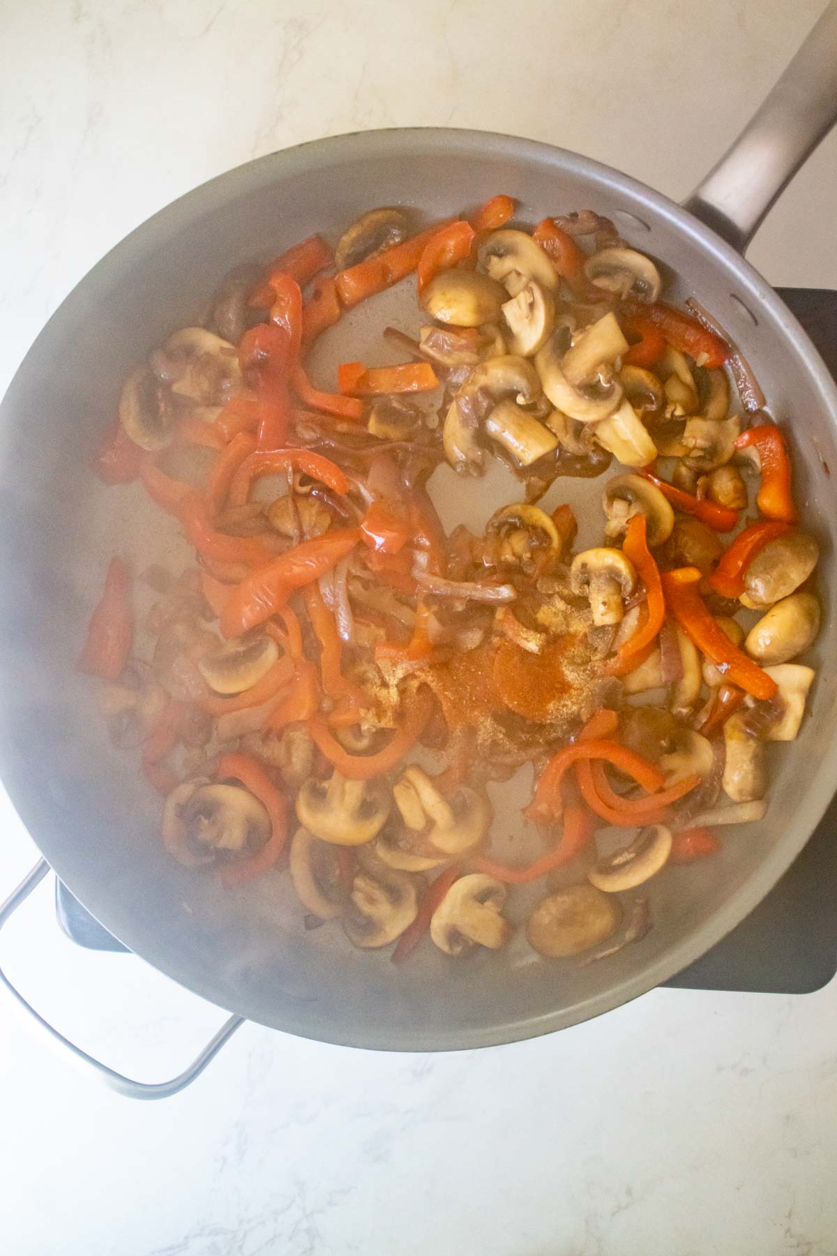 adding vegan Worcestershire sauce and spices to the pan