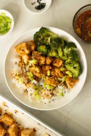 bowl of sheet pan honey garlic tofu with broccoli and rice after garnishing