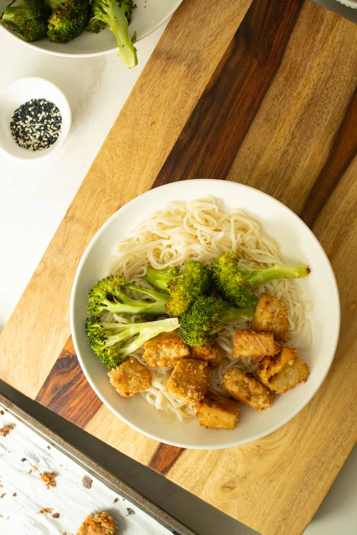 tofu and broccoli added to the bowl
