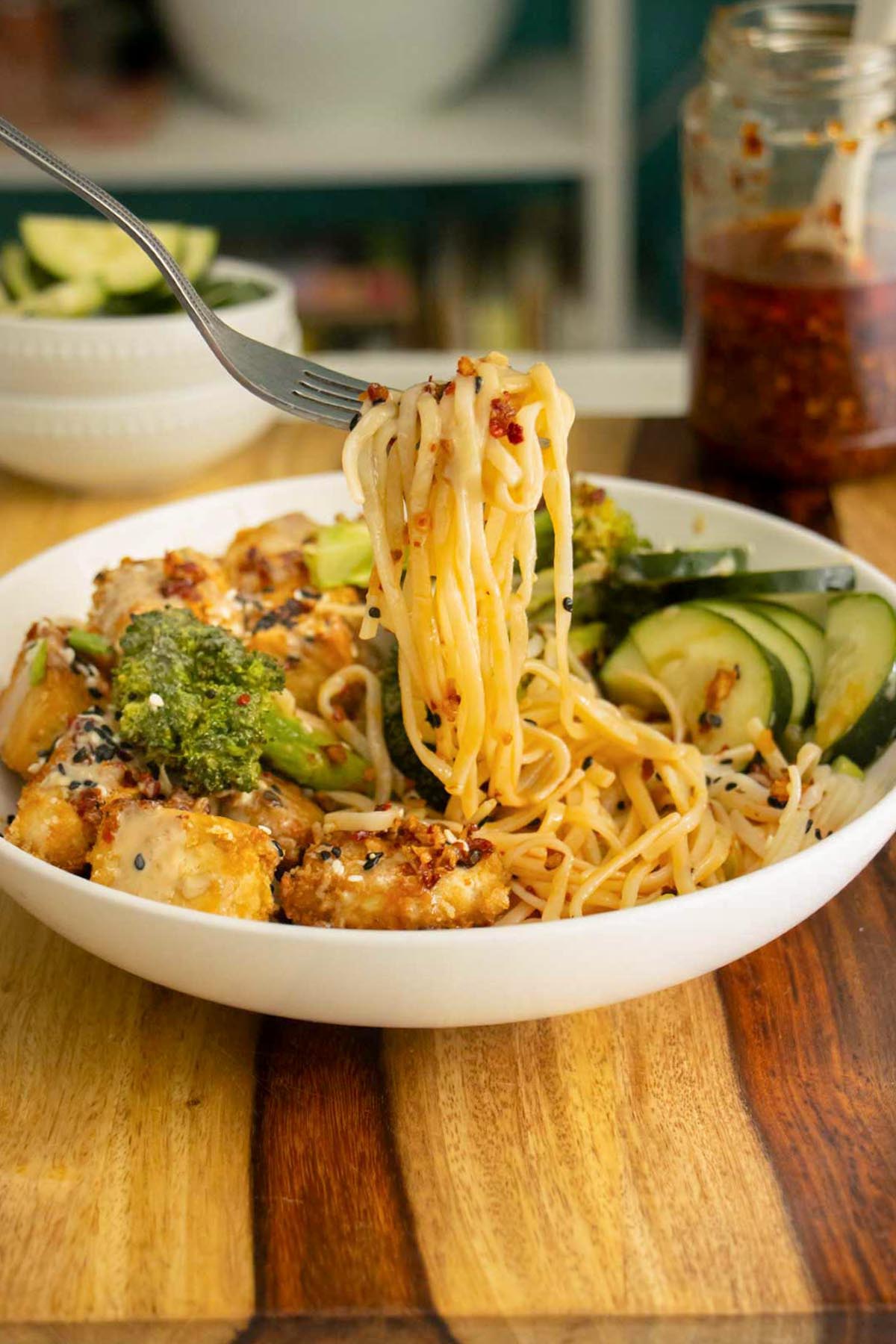 fork taking a bite of creamy chili crisp noodles