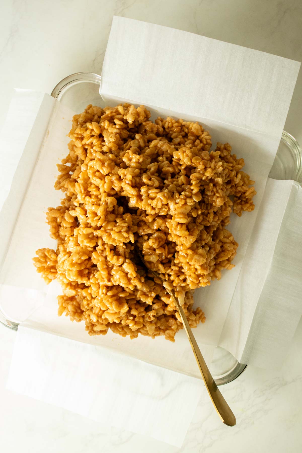 adding the peanut butter-cereal mixture to the pan