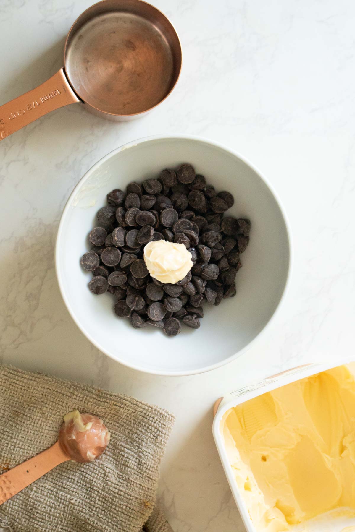 vegan chocolate chips and vegan butter in a bowl before melting