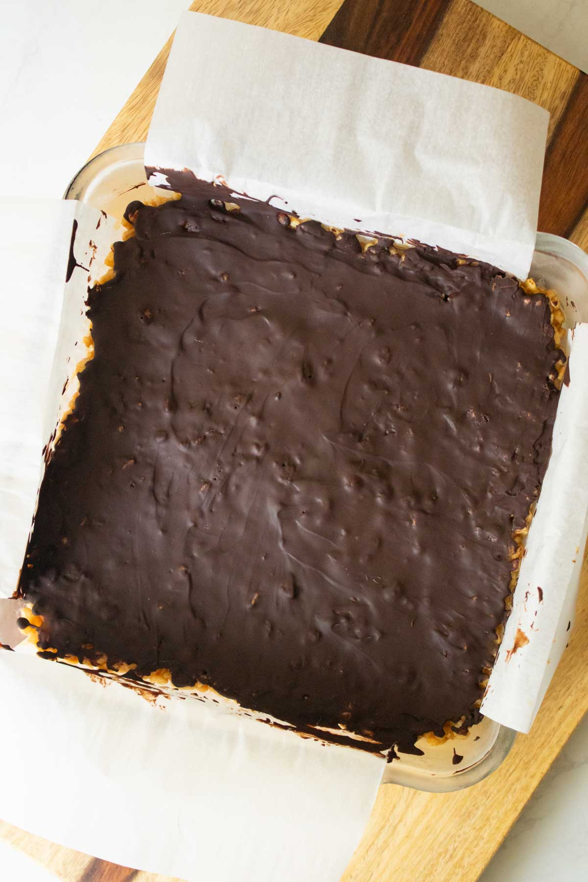 chocolate peanut butter rice crispy treats in the pan after chilling and slicing