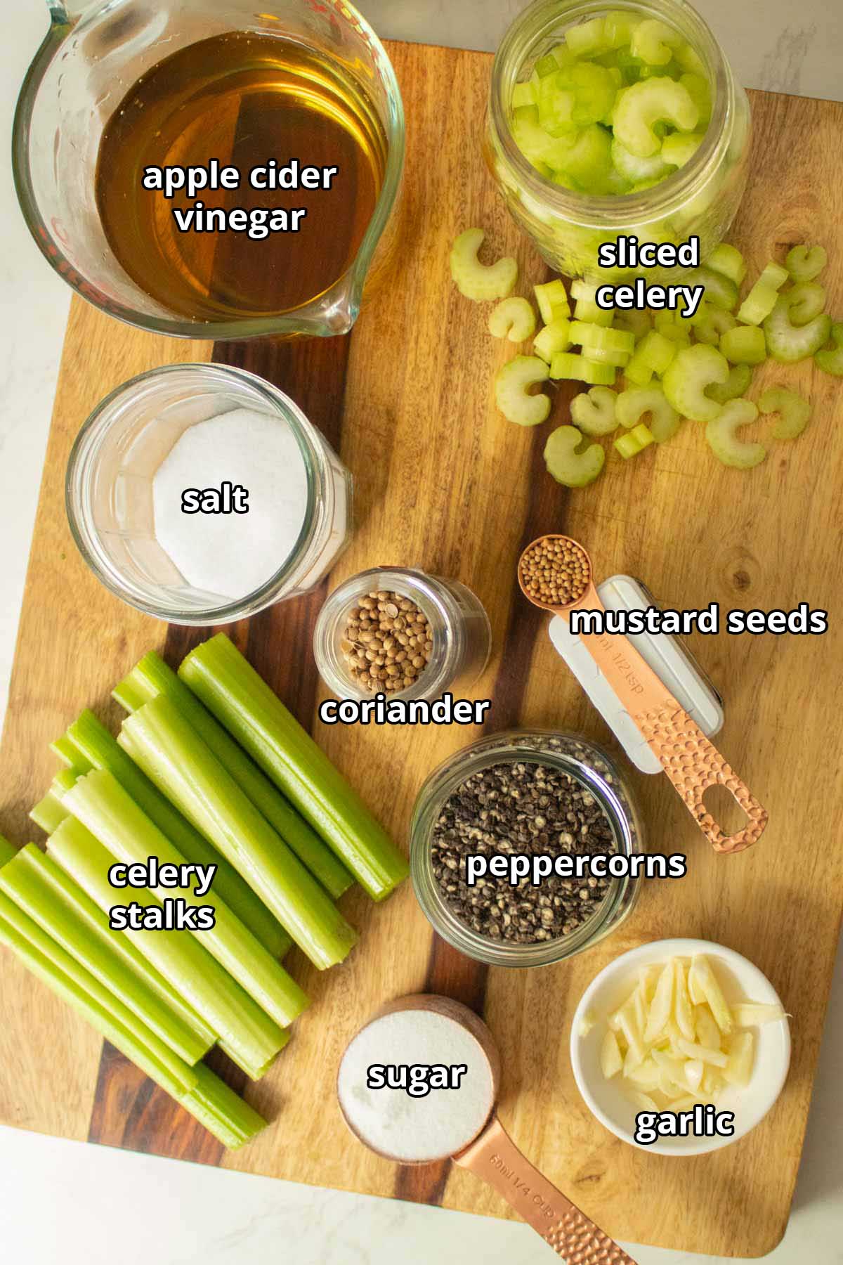 quick pickled celery ingredients on a wooden cutting board, text labels