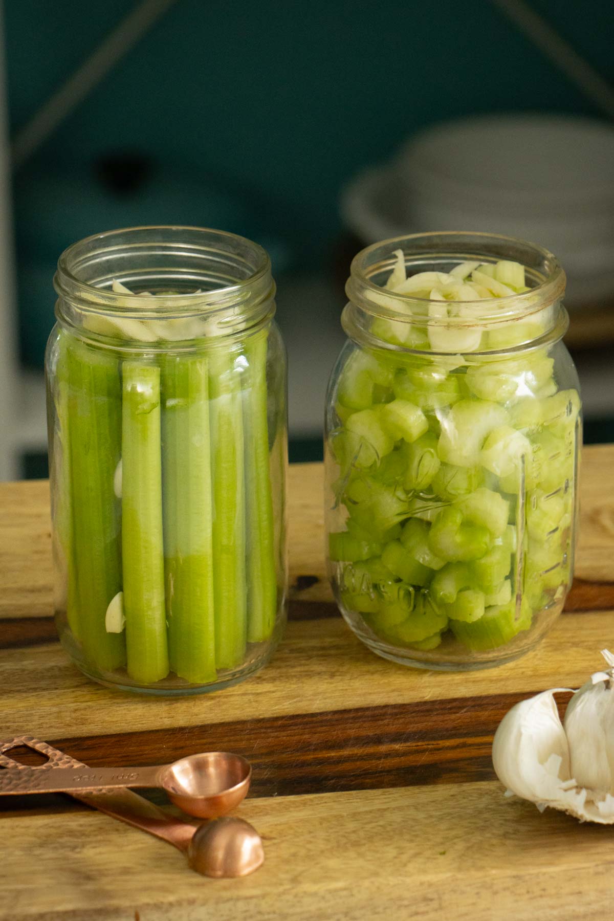 garlic and celery spears and slices stuffed into jars