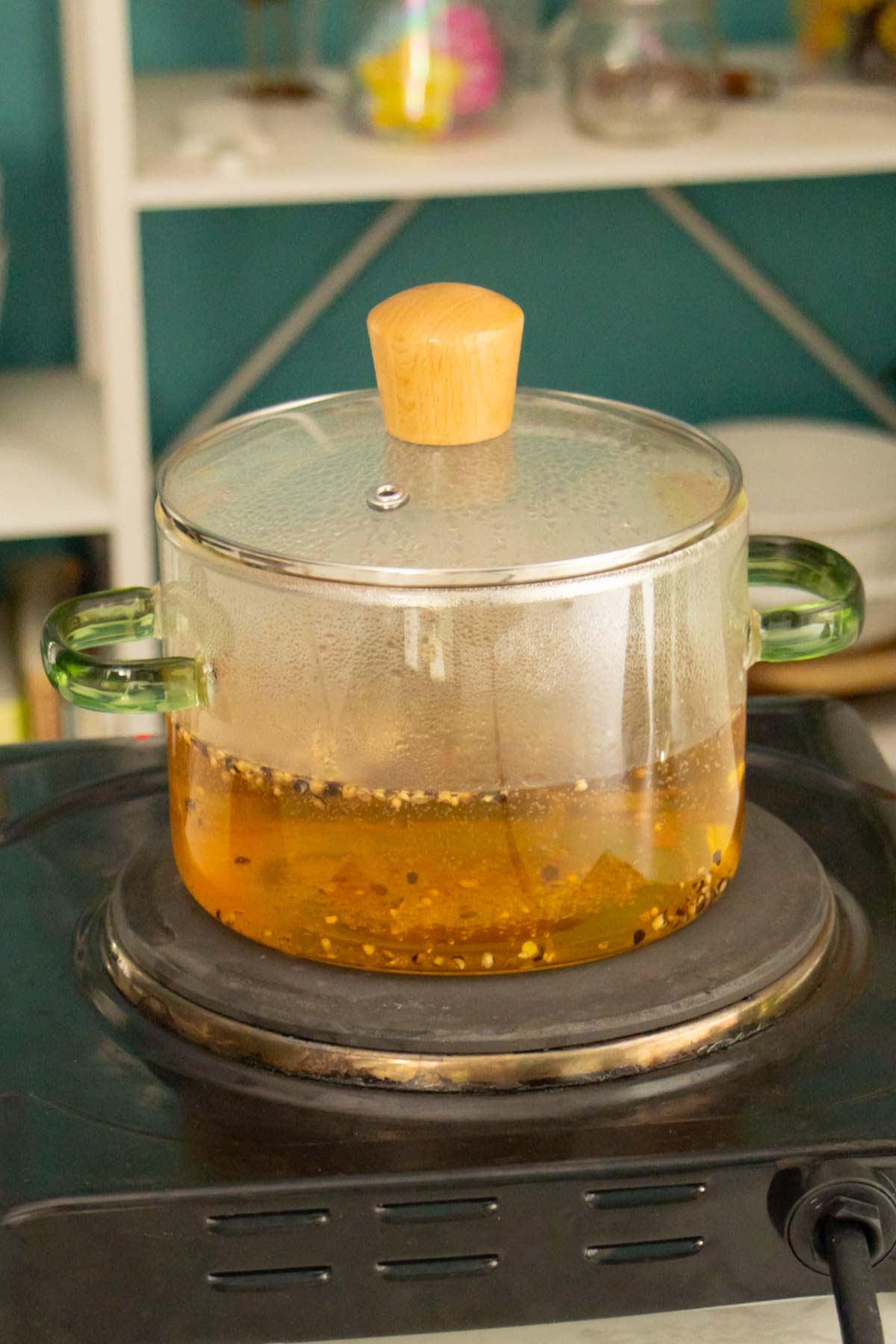 brine ingredients boiling in a glass pot on the stovetop