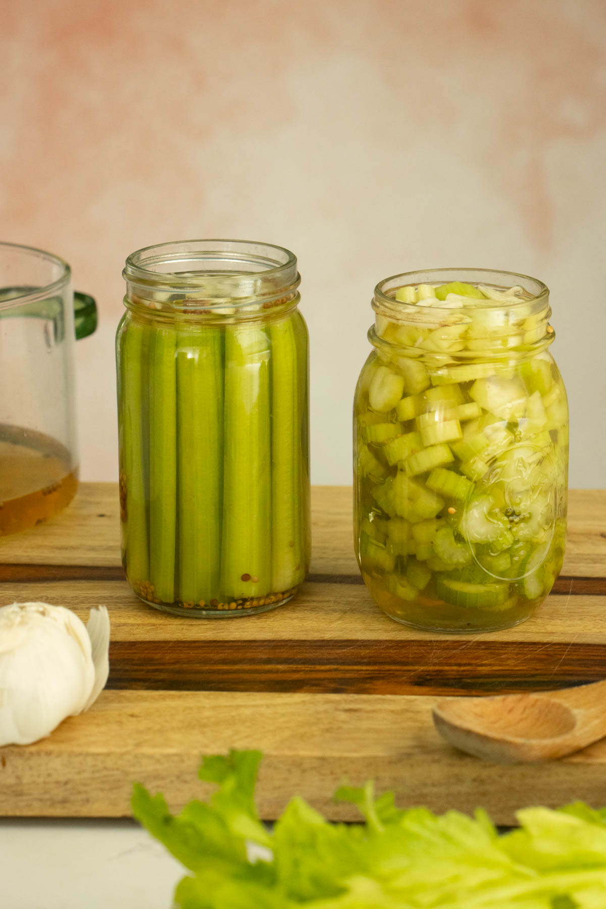 celery spears and slices in jars after pouring on the brine